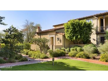 Spanish style home with landscaped front yard and walkway at 18650 N Thompson Peak Pkwy # 1070, Scottsdale, AZ 85255