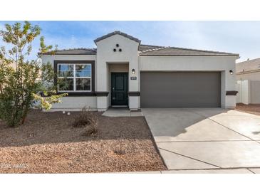 One-story home with a gray garage door and desert landscaping at 18793 W Farmer Rd, Buckeye, AZ 85326