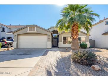 Single-story home with a two-car garage and desert landscaping at 1435 E Debbie Dr, San Tan Valley, AZ 85140