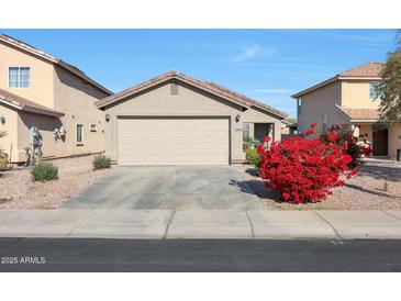 House exterior featuring a two-car garage and landscaping at 22814 W Cantilever St, Buckeye, AZ 85326