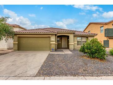 Front view of a single-story house with a green garage door at 2440 W Bloch Rd, Phoenix, AZ 85041