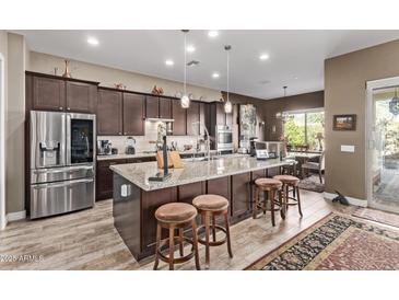 Modern kitchen with stainless steel appliances and granite countertops at 9814 W Rowel Rd, Peoria, AZ 85383