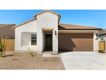 Inviting single-story home featuring a private entryway, a two car garage and low maintenance landscaping at 16580 N Dante Way, Maricopa, AZ 85138