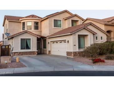 Two-story house with a large garage and nicely landscaped front yard at 25696 W Williams Ct, Buckeye, AZ 85326