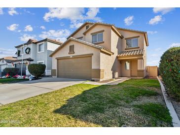 Two-story house with a landscaped yard and two-car garage at 38245 N Jonathan St, San Tan Valley, AZ 85140