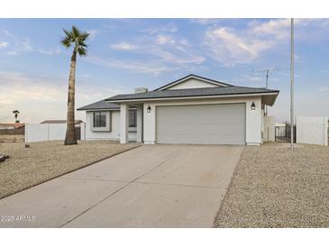 Single-story home with attached garage and desert landscaping at 15455 S Williams Pl, Arizona City, AZ 85123