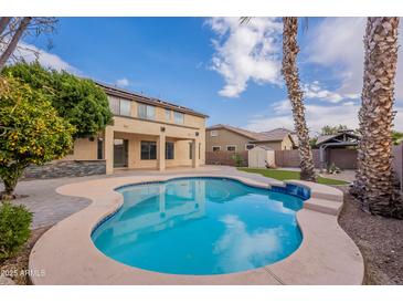 Inviting kidney shaped pool with surrounding patio at 1923 E Zion Way, Chandler, AZ 85249