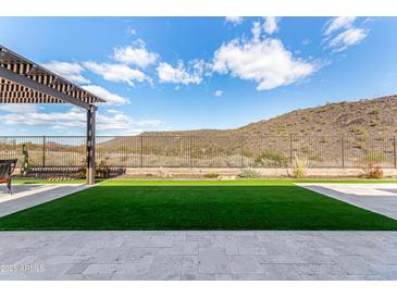 Artificial turf backyard with pergola and mountain views at 11578 W Montansoro Ln, Peoria, AZ 85383