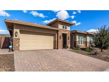 Craftsman style home with stone accents and a 3-car garage at 11578 W Montansoro Ln, Peoria, AZ 85383