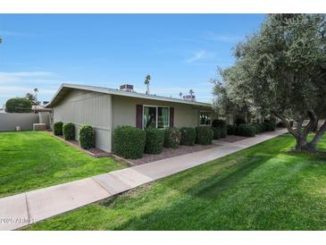 Side view of the house showing landscaping and walkway at 13607 N 111Th Ave, Sun City, AZ 85351