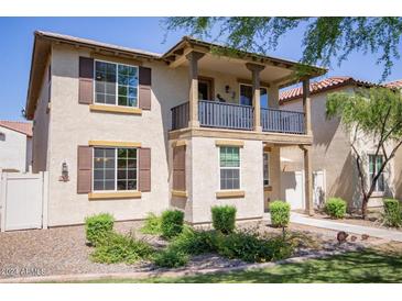 Two-story home with balcony, landscaping, and a walkway at 29068 N 124Th Dr, Peoria, AZ 85383
