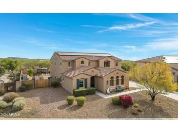 Two-story house with solar panels, pool, and landscaped yard at 31271 N 133Rd Dr, Peoria, AZ 85383