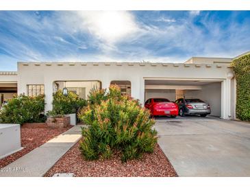 Two-car garage with attractive landscaping and a white stucco exterior at 8715 E Via De Viva --, Scottsdale, AZ 85258