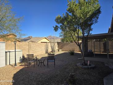 Small backyard with gravel, patio furniture, and a covered patio at 8944 E Red Mountain Ln, Gold Canyon, AZ 85118