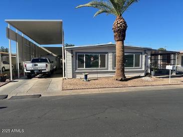 Single wide home with carport and mature palm tree at 16210 N 32Nd Way, Phoenix, AZ 85032