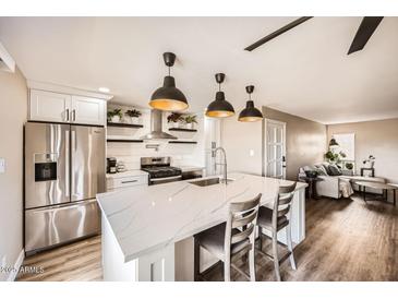 Modern kitchen with stainless steel appliances and a large island at 4950 N Miller Rd # 210, Scottsdale, AZ 85251