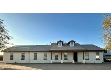 House exterior features a light-colored facade, tile roof, and front porch at 50011 W Mayer Blvd, Maricopa, AZ 85139