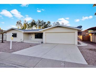 Ranch style home with attached two-car garage and desert landscaping at 5113 E Florian Ave, Mesa, AZ 85206