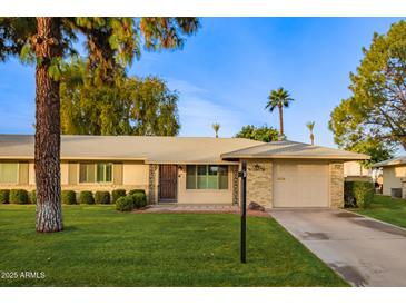 Single-story home with a landscaped lawn and attached garage at 15446 N Lakeforest Dr, Sun City, AZ 85351