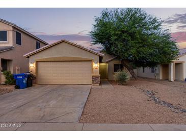 Single story home with attached garage and landscaped front yard at 2017 N 103Rd Dr, Avondale, AZ 85392