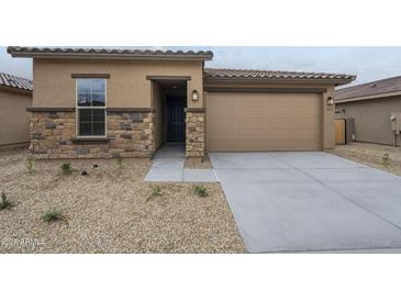 Charming single-Gathering home featuring stone accents, a two-car garage, and desert landscaping at 24177 W Hilton Ave, Buckeye, AZ 85326