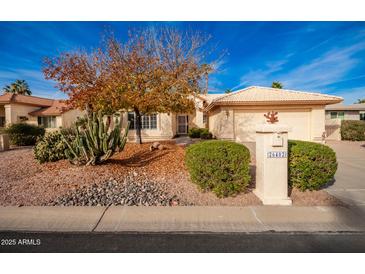 Single-story home with desert landscaping and a two-car garage at 26402 S Howard Dr, Sun Lakes, AZ 85248