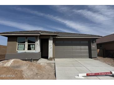 Charming single-story home showcasing a clean design, fresh driveway, and an inviting two-car garage at 31277 N 130Th Ave, Peoria, AZ 85383