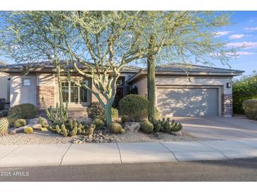 Single-story home with desert landscaping and a two-car garage at 3525 E Robin Ln, Phoenix, AZ 85050