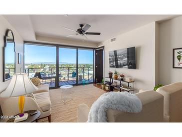 Bright living room with city views, hardwood floors, and comfortable seating at 4422 N 75Th St # 7009, Scottsdale, AZ 85251