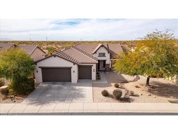 Single-story house with two-car garage and desert landscaping at 47970 N Navidad Ct, Gold Canyon, AZ 85118
