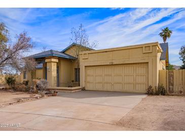 Single story home with attached garage and desert landscaping at 6701 W Monterey Way, Phoenix, AZ 85033