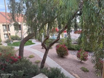 Ground level view of a community with walking paths, landscaping, and a pool at 9708 E Via Linda -- # 2322, Scottsdale, AZ 85258