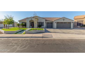 Beautiful one-story home with a landscaped front yard and two-car garage at 9845 E Natal Ave, Mesa, AZ 85209