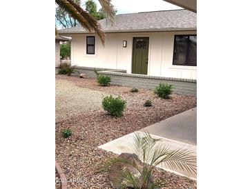 Charming home featuring desert landscaping, an olive-painted front door, and a cozy, inviting appeal at 12432 W Fieldstone Dr, Sun City West, AZ 85375
