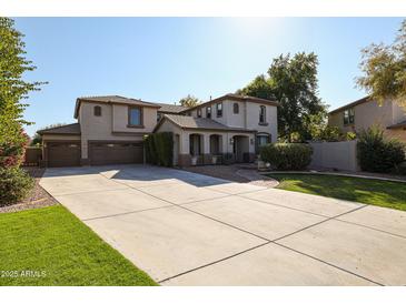 Two-story house with a three-car garage and manicured lawn at 1737 E Carob Dr, Chandler, AZ 85286