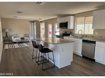 Bright kitchen with stainless steel appliances, granite countertops, and an island with bar stool seating at 205 S Higley Rd # 4, Mesa, AZ 85206