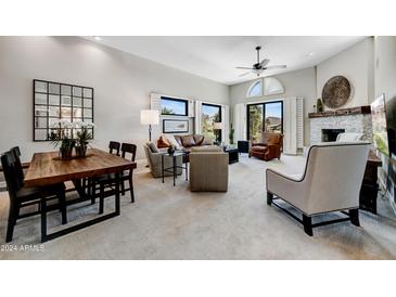 Spacious living room featuring a fireplace and large windows at 25515 N Forest Rd # 16, Rio Verde, AZ 85263