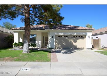 Single-story home with a two-car garage and well-maintained lawn at 2732 W Lamar Rd, Phoenix, AZ 85017