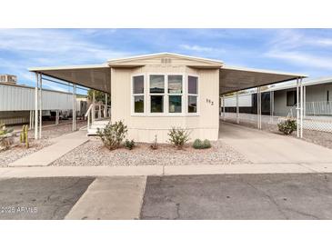 Mobile home exterior with carport and landscaping at 300 S Val Vista Dr # 152, Mesa, AZ 85204