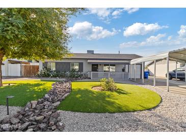 Single-story home with landscaped yard and carport at 3727 W Orangewood Ave, Phoenix, AZ 85051