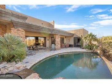Luxury backyard oasis featuring a large pool, spacious patio, and stunning mountain views at 39816 N 106Th Pl, Scottsdale, AZ 85262