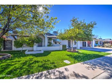 Beautiful mid-century modern home with landscaped lawn and updated facade at 8349 E Columbus Ave, Scottsdale, AZ 85251