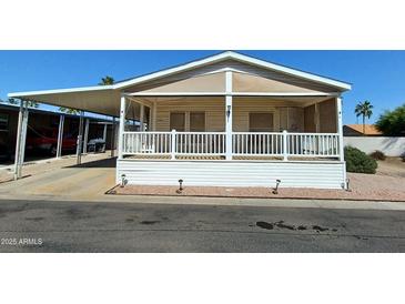 Single-wide manufactured home with covered porch and carport at 9333 E University Dr # 196, Mesa, AZ 85207