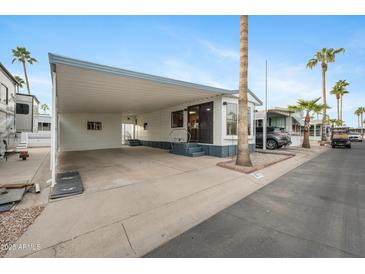 Mobile home exterior with carport and landscaping at 977 S Oxide Dr # 977, Apache Junction, AZ 85119