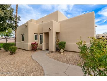 Tan stucco exterior with landscaped walkway at 11333 N 92Nd St # 1131, Scottsdale, AZ 85260