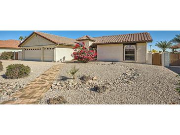 Single-story home with a two-car garage and landscaped front yard at 13009 S 42Nd Pl, Phoenix, AZ 85044