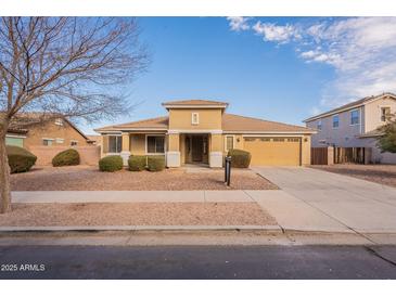 Single-story house with tan exterior, landscaped yard, and driveway at 18526 E Swan Dr, Queen Creek, AZ 85142