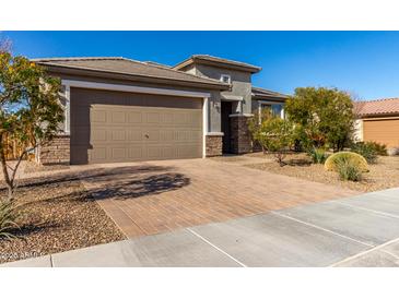 Single-story home with a two-car garage and desert landscaping at 21778 N 259Th Ln, Buckeye, AZ 85396