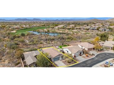 A lovely exterior aerial view of a home with a manicured lawn, landscaping, and mountain views at 41512 N Tangle Ridge Ct, Anthem, AZ 85086