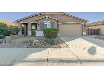 One-story house with a two-car garage and landscaped front yard at 1113 W Fir Tree Rd, Queen Creek, AZ 85140